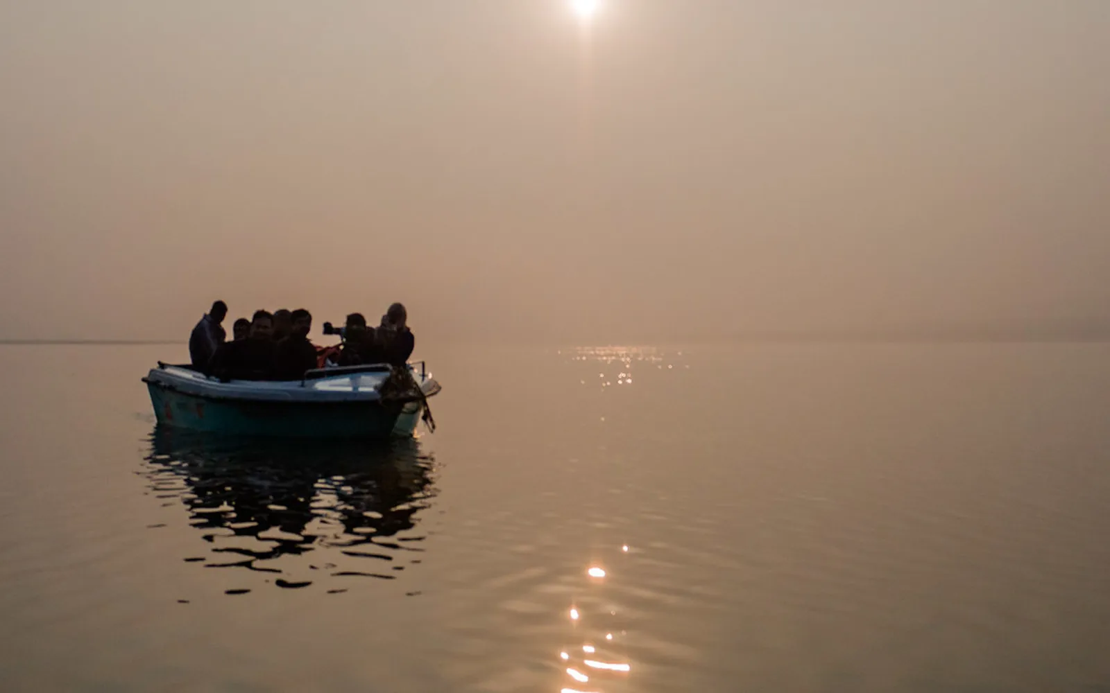 A boat on the Chambal River on a foggy winter sunrise